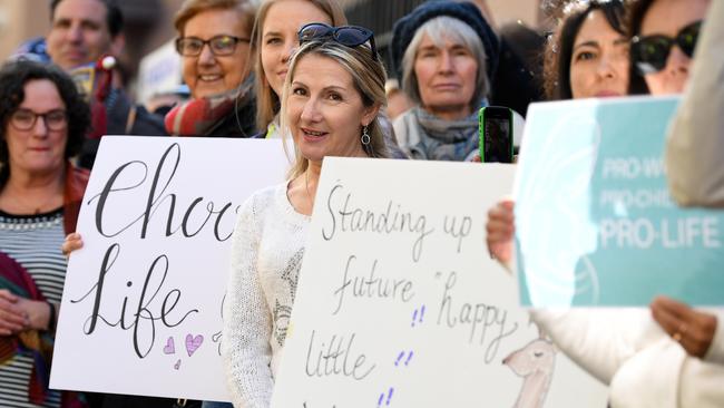 Anti-abortion protesters hold signs during a rally outside the New South Wales Parliament House in Sydney. Picture: AAP