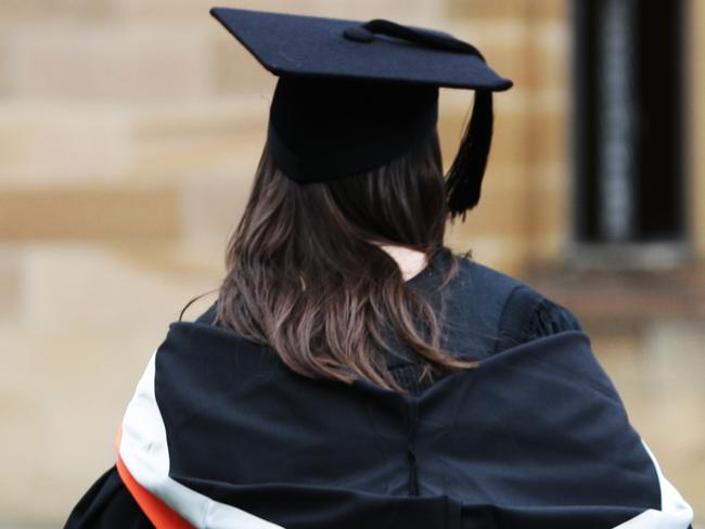 University students wearing their graduation mortar board hats and gowns for their graduation ceremony on campus at Sydney University in Sydney.