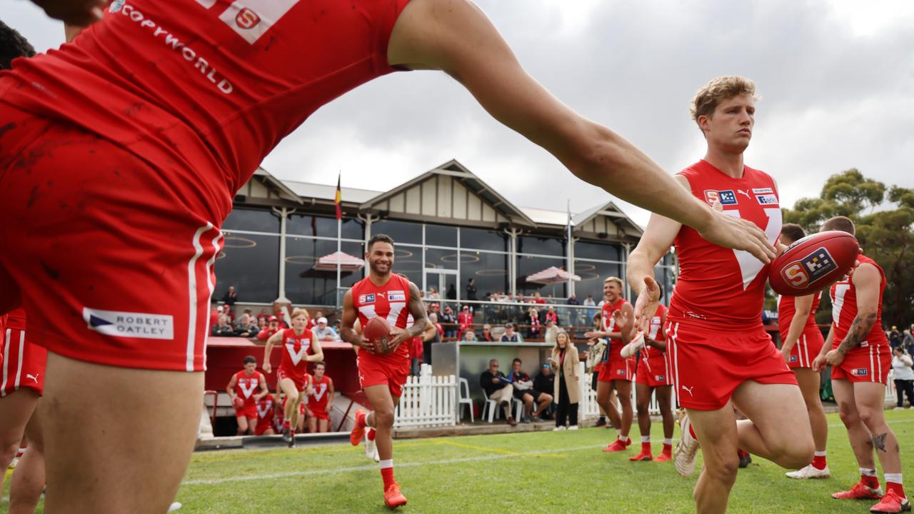 Roosters players run onto the field during the Round 4 SANFL match between North Adelaide and Woodville West Torrens at Prospect Oval. Picture: David Mariuz