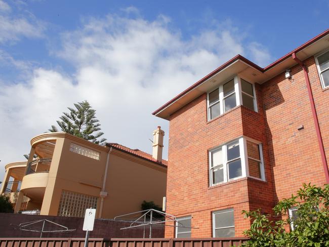 The contrast between a private Mosman property and the vacant public housing block. Picture: ADAM WARD