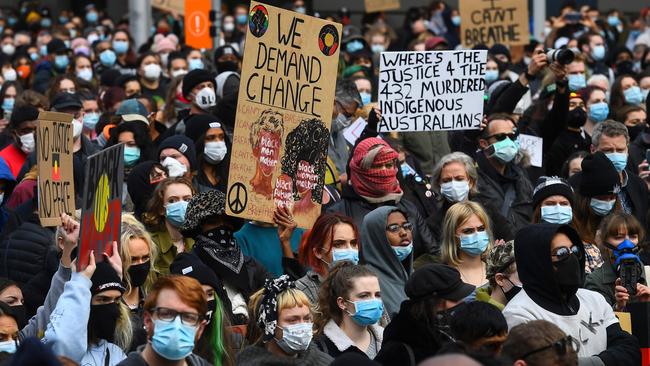 People hold up placards at a Black Lives Matter protest in Melbourne. Picture: AFP