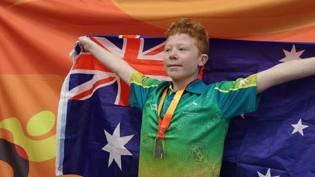 Robbie Yates with the Australian Flag at the World Transplant Games in Perth. Picture: Supplied