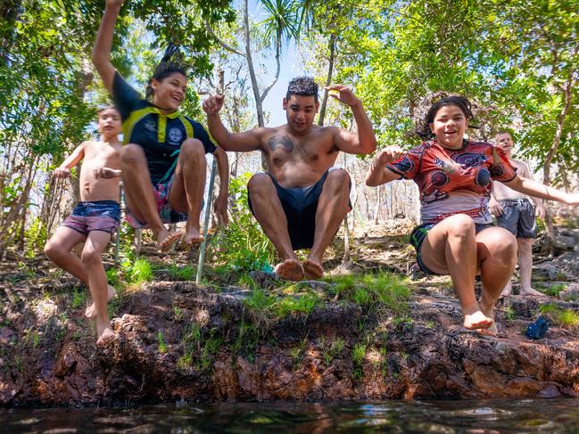 The first weekend of National Parks opening during the coronavirus pandemic in the Top End saw droves of day-trippers and campers fill Litchfield National Park. Sharma Ah-Wing, Cieanna Ah-Wing, Ronald Ah-Wing and Chanelle Ah-Wing jump into Buley Rock Hole. Picture: Che Chorley