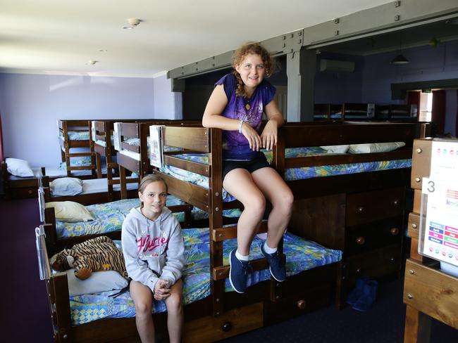 Cassandra, 11 and Sariah, 12, show off the dorms in Stewart House.