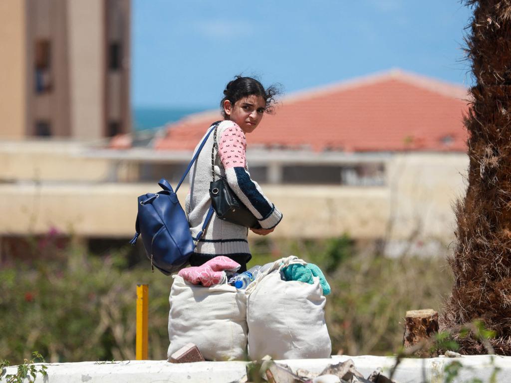 Displaced Palestinians who left with their belongings from Rafah in the southern Gaza Strip following an evacuation order by the Israeli army, unload their belongings to set up shelter in Khan Yunis. Picture: AFP