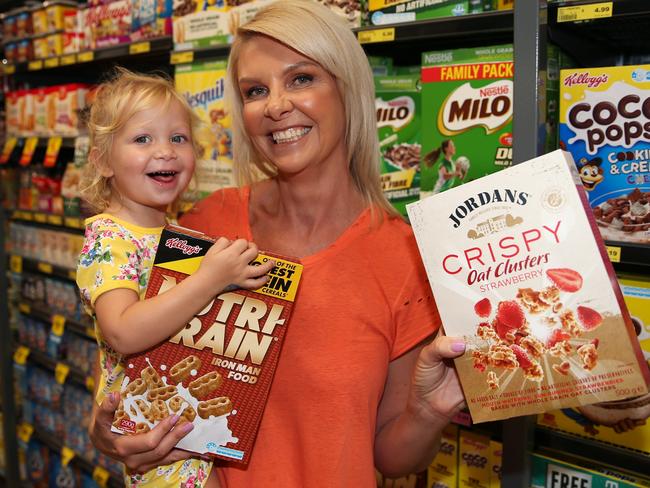 Belinda MacDougall with daughter Milla, two, check out the labelling on food products in a Newcastle supermarket. Picture: Peter Lorimer.