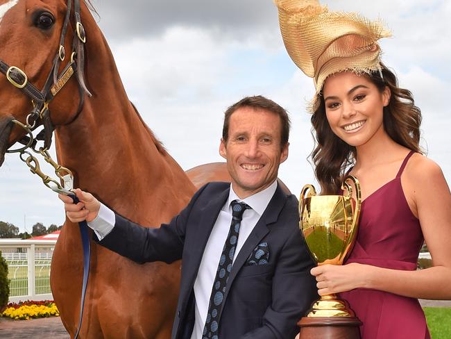 Melbourne Racing Clubâ€™s economic impact to the Victorian Economy  Jockey Damien Oliver with  race horse, Hero and Elissa from Vivien's Model Management with the Caulfield Cup at the Caulfield Race Track. Picture: Tony Gough