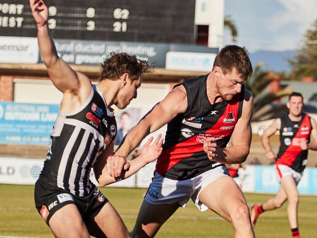 Port's Boyd Woodcock and West's Jonathon Beech at Alberton Oval, Sunday, July 7, 2019. Picture: MATT LOXTON