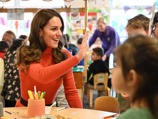 The radiant Princess high-fives kids at the Foxcubs Nursery in Luton. Picture: AFP