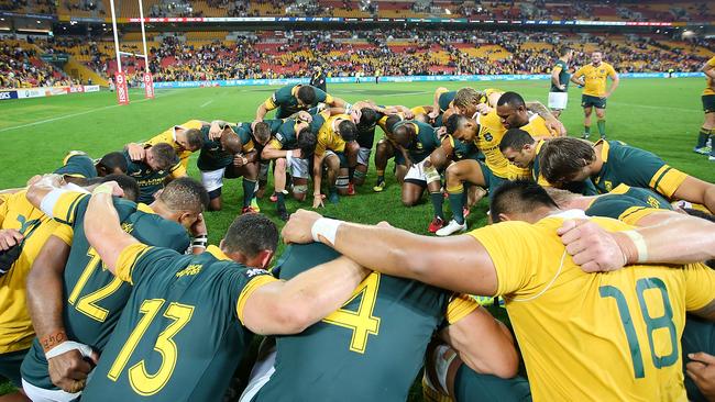 Wallabies and Springboks huddle in prayer after a Test match. Picture: Getty