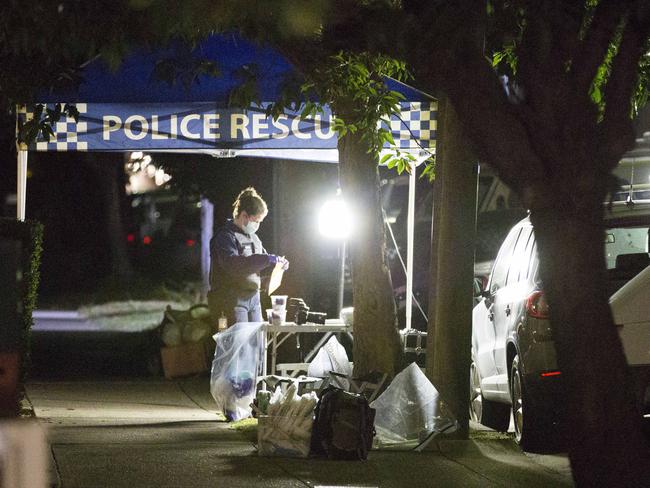 A Federal police forensics police officer on Sproule Street in Lakemba.