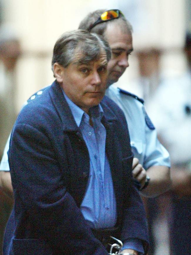 Four-time killer Bandali Debs in handcuffs as he is led into the Supreme Court to face trial over the 1988 murders of police officers Gary Silk and Rod Miller.