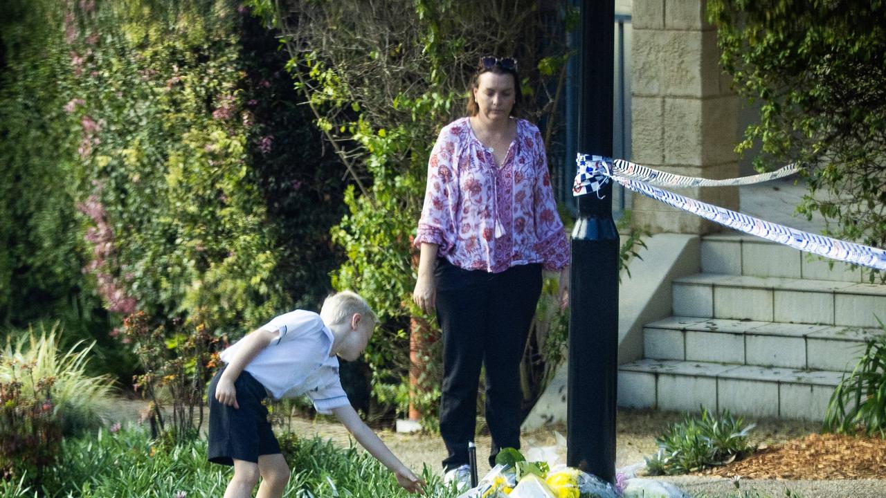 Mourners lay flowers at the family home. Picture: Nigel Hallett