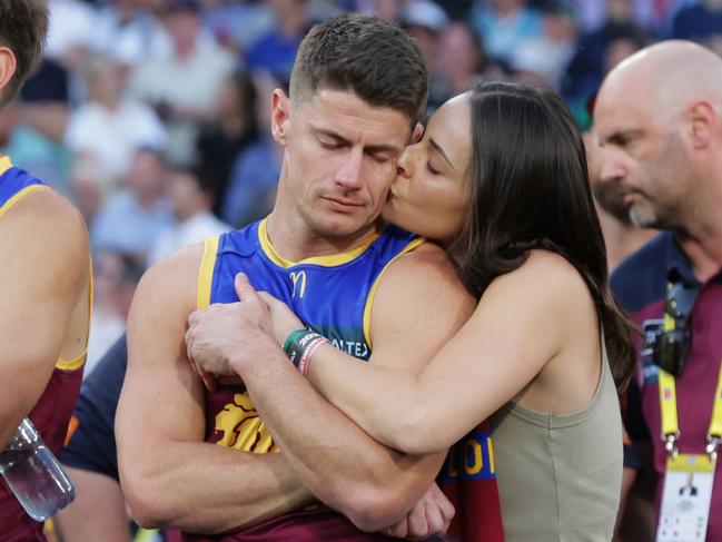 Dayne Zorko is comforted by partner Talia De Marco after the siren at the 2023 AFL Grand Final where Collingwood defeated the Brisbane Lions by 4 points at the MCG. Picture Lachie Millard