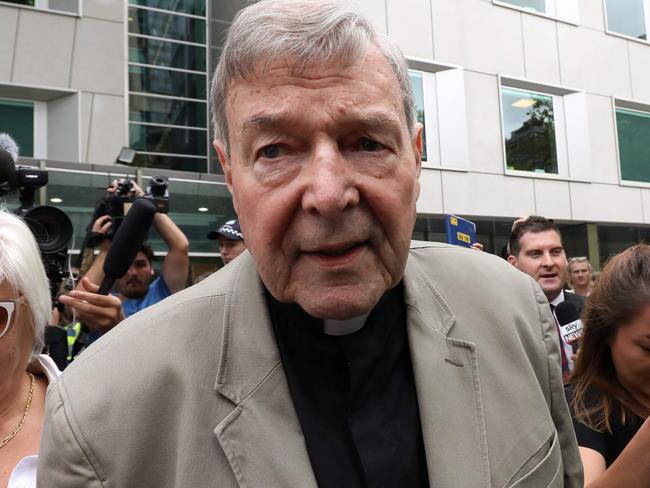 (FILES) In this file photo taken on February 26, 2019 Cardinal George Pell (C) leaves the County Court of Victoria court after prosecutors decided not to proceed with a second trial on alleged historical child sexual offences in Melbourne. - Disgraced Australian Cardinal Pell was sentenced to six years in jail for child sex crimes in a Melbourne court on March 13, 2019, with a non-parole period of three years and eight months. (Photo by Asanka Brendon Ratnayake / AFP)