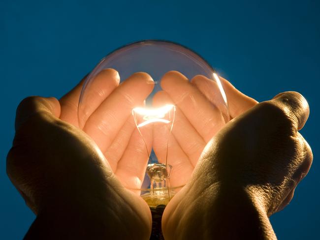 Stock image of hands holding light bulb