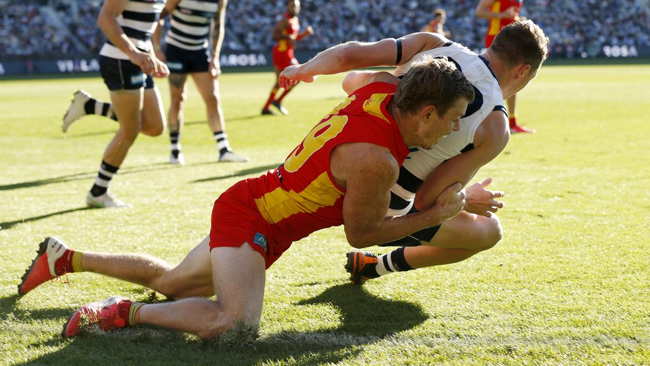 GEELONG, AUSTRALIA - MAY 22: Nick Holman of the Suns tackles Mitch Duncan of the Cats during the round 10 AFL match between the Geelong Cats and the Gold Coast Suns at GMHBA Stadium on May 22, 2021 in Geelong, Australia. (Photo by Darrian Traynor/AFL Photos/via Getty Images)