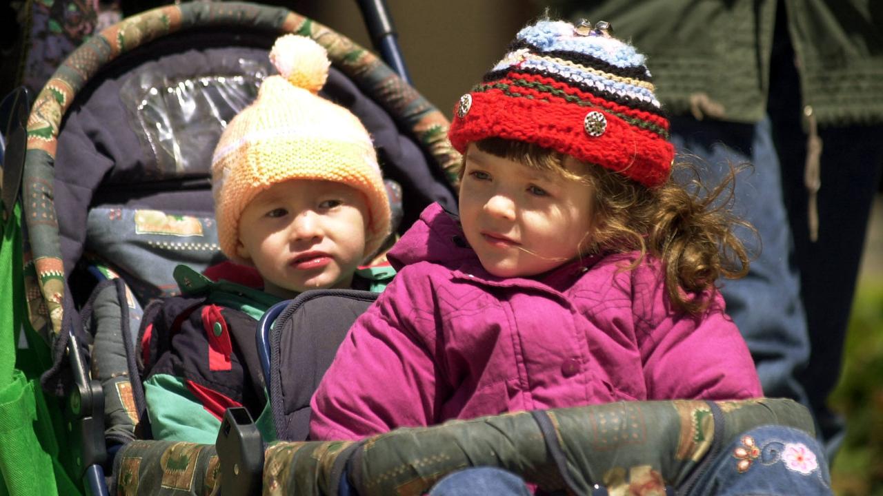 Lachlan Duncan 2yrs with sister Mary-Rose of Toowoomba rugged up to view the cancelled parade as strong wind gusts forced the cancellation of the Toowoomba Carnival of Flowers Parade. Picture: David Martinelli.