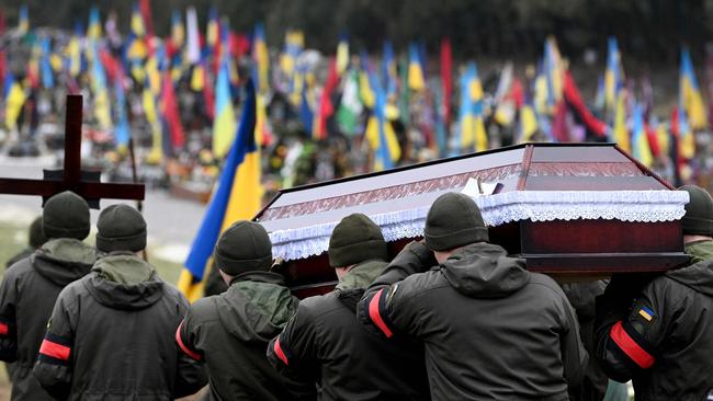 Ukrainian soldiers carry the coffin of their comrade killed in combat with Russian troops. Picture: Yuriy DYACHYSHYN/AFP