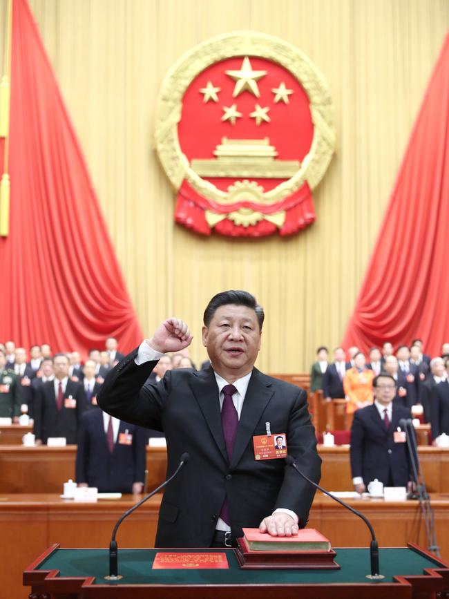 Xi Jinping takes a public oath of allegiance to the Constitution in the Great Hall of the People in Beijing.