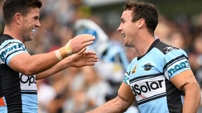 James Maloney (right) of the Sharks is congratulated by Chad Townsend after scoring a try during the round 7 NRL match between the Penrith Panthers and the Cronulla Sutherland Sharks at Pepper Stadium in Sydney on Sunday, April 16, 2017. (AAP Image/Paul Miller) NO ARCHIVING, EDITORIAL USE ONLY