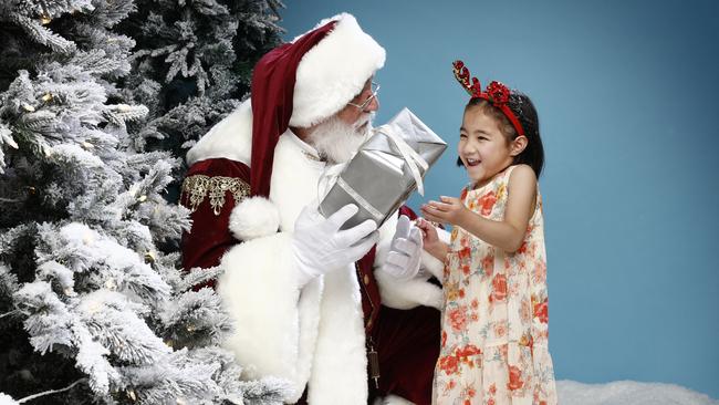 Santa with Christmas fan Ellie Cheng ahead of The Christmas Portal, an immersive Christmas experience at The Venue Alexandria. Picture: Richard Dobson