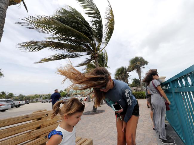 Locals face the wind and rain in Florida. Picture: AP