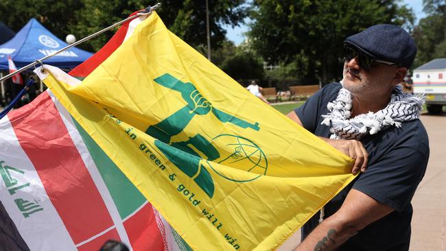 Protesters held yellow and green flags that bore similarities to the Hezbollah flag. Picture: NewsWire/ Damian Shaw