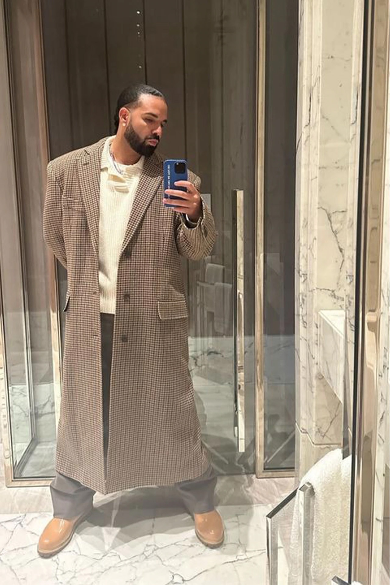 <p><em>Image credit: Instagram/champagnepapi</em></p><p>&nbsp;</p><h3>Drake in Commas</h3><p>&nbsp;</p><p>In one of Drake&rsquo;s sporadic Instagram stories, the rapper dropped a pic of him in a marbled bathroom. Layered underneath his checked coat was an ecru-coloured merino polo sweater from Commas. A relaxed, high-quality staple, a merino sweater of this ilk has a place in just about any wardrobe&mdash;Drake&rsquo;s or yours.</p>