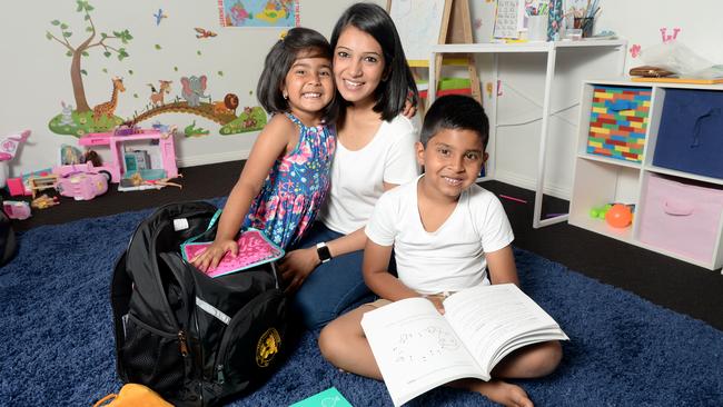 Jeshlyn Ranasinghe helps her kids Jiya, 4, and Aiden, 6, prepare for the new school year. Picture: Andrew Henshaw