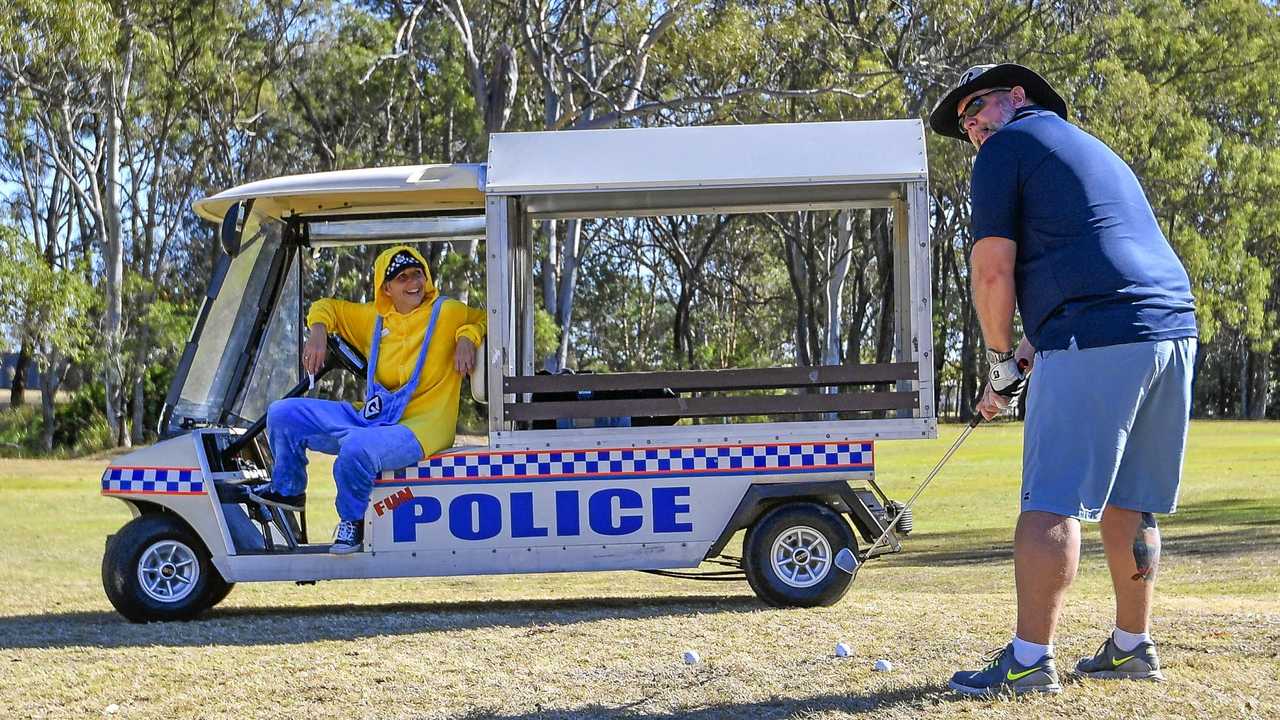 Colleen Smith watches on as Tony Noyes takes a shot at the Andersons Auto City Gladstone Police Charity Golf Day held at Gladstone Golf Club on 9 August 2019. Picture: Matt Taylor GLA090819GOLF