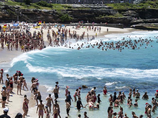 Extra lifesavers were on hand to guide people back between the red and yellow flags, calling on swimmers to stay close to shore. Picture: Daily Telegraph/ Monique Harme