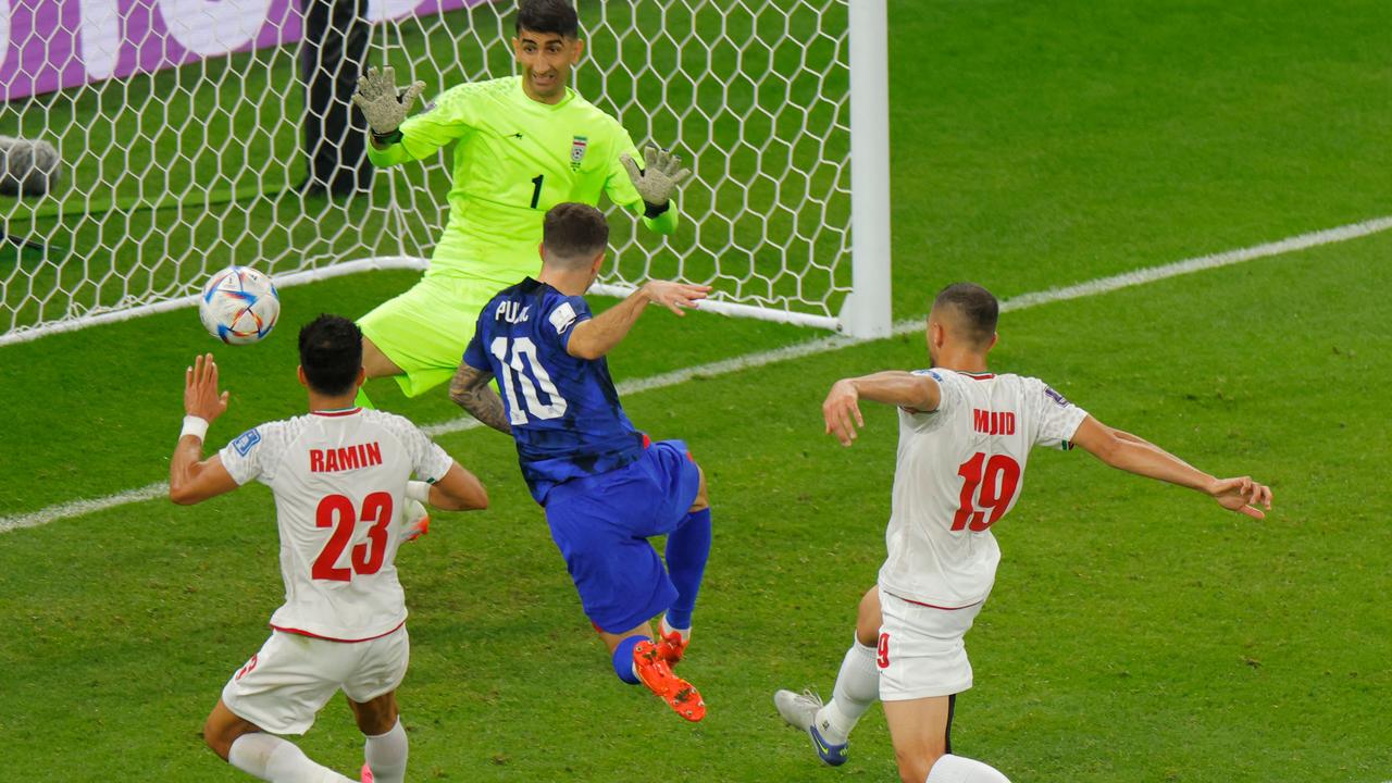 Pulisic fired home but copped a whack from the Iranian goalkeeper in the process. (Photo by Odd ANDERSEN / AFP)