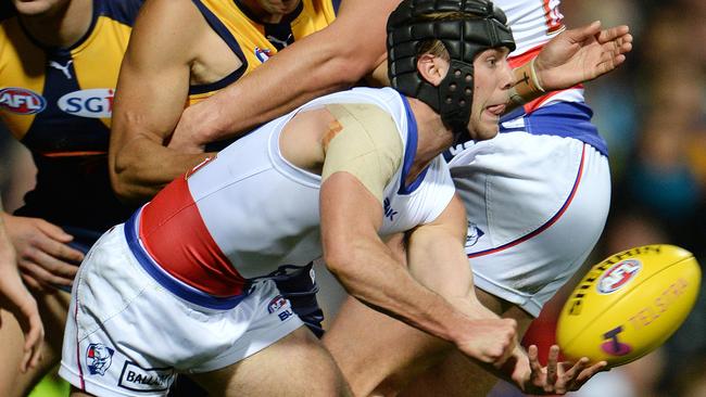 Caleb Daniel gets a handball away to set-up teammate Luke Dahlhaus for a goal against the Eagles.