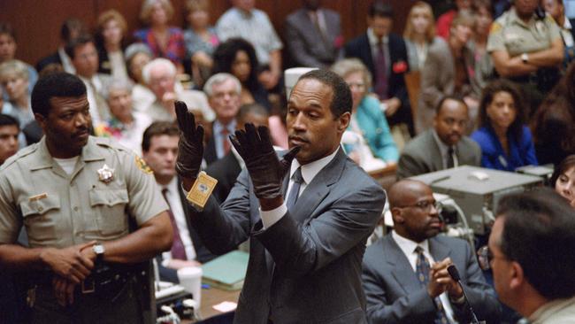 Simpson trying on gloves during his double murder trial in Los Angeles. (Photo by Vince BUCCI / AFP)