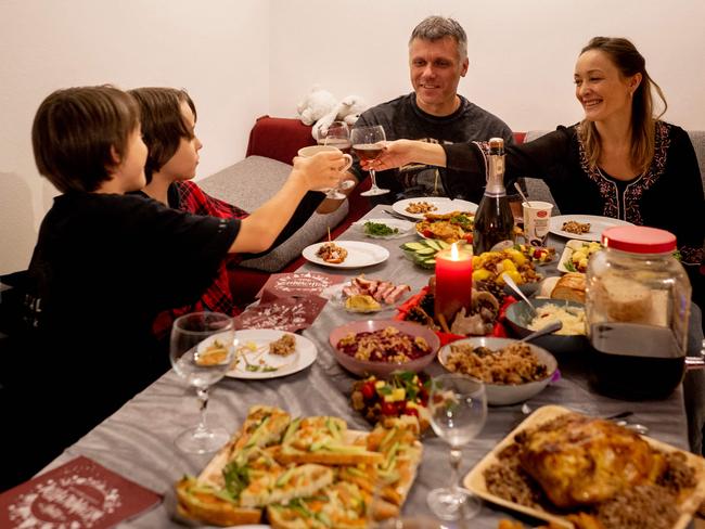 Ukrainian parents Valerii and Irina Titkova toast sons Danylo and Denys as they celebrate their first Orthodox Christmas in exile, in Vienna, Austria. Picture: AFP