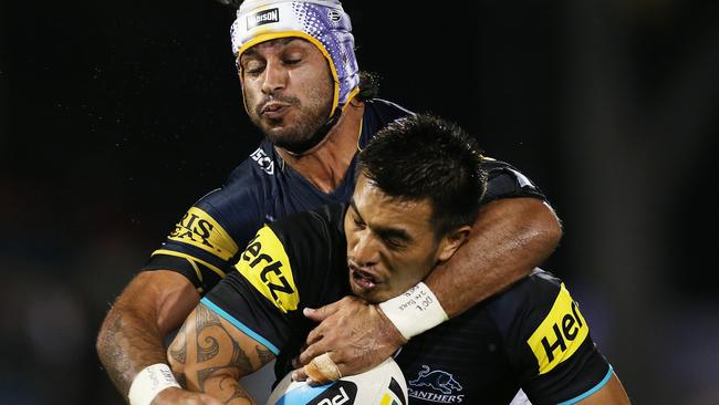 Cowboys Johnathan Thurston makes a tackle on Penrith's Dean Whare during NRL match Penrith Panthers v Nth Qld Cowboys at Penrith. pic. Phil Hillyard