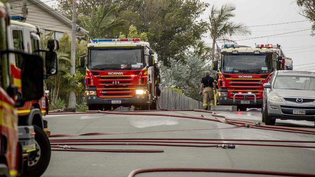 Emergency services including police and fire fighters at the scene of a house fire involving the two homes. Picture: Jerad Williams