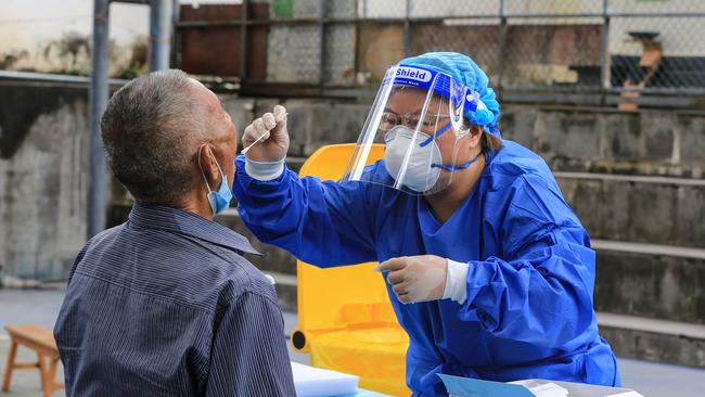 A man is given a nucleic acid test for coronavirus in China's southwestern Yunnan province on the weekend. Picture: AFP