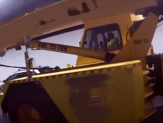 Caught … The crane driver on his mobile inside the Lane Cove Tunnel. Picture: NSW Police