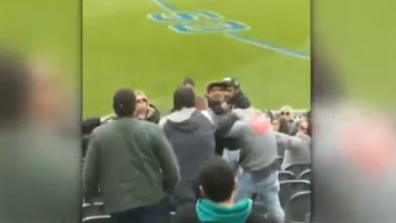 Fans fight in the Carlton members section at the MCG. Credit: 7 News