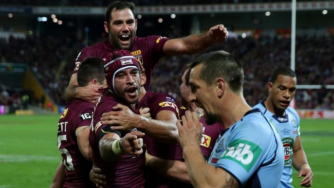 Johnathan Thurston delivers an Mitch Pearce an all-time Origin spray after QLD scored a try in the 2015 Game 3 decider. Picture Gregg Porteous