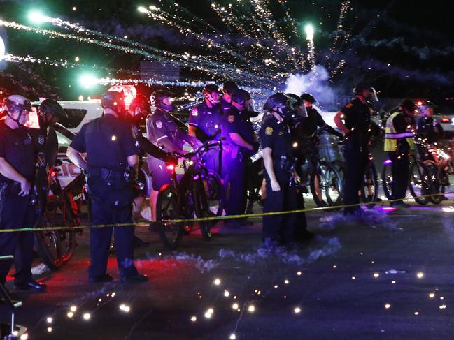 Protesters throw fireworks at officers on Busch Blvd. in Tampa as they demonstrate against police brutality in Tampa, Florida. Picture: AP