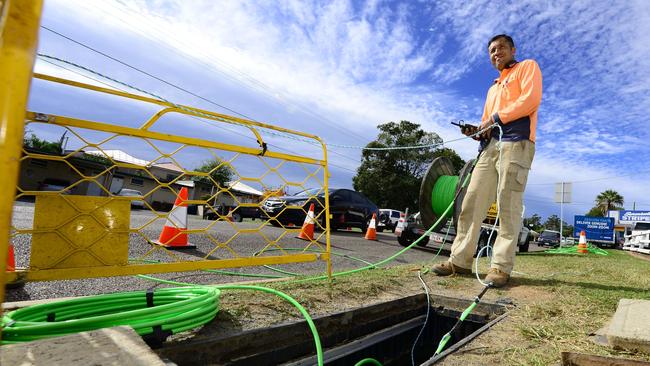 A worker laying down fibre optic cable as part of the NBN rollout. Picture: David Nielsen