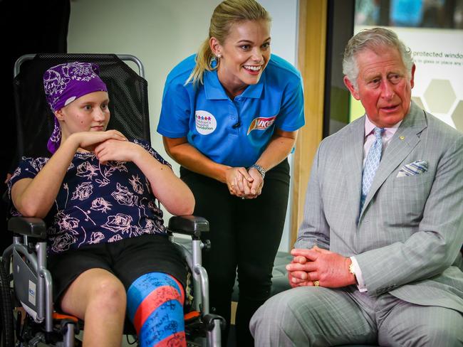 Abbi Head, 13, and a staff member welcome Prince Charles to Lady Cilento Children’s Hospital on Wednesday. Picture: Patrick Hamilton/Getty Images