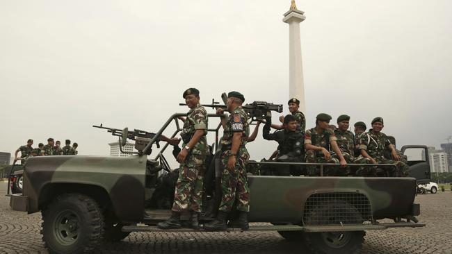 Indonesian soldiers patrol at Monas, the national monument, in Jakarta, on Friday ahead of a much-hyped protest by Muslim hardliners against the city’s popular governor. Picture: AP/Achmad Ibrahim