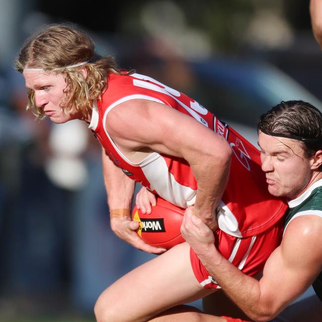 Shepparton Swans’ Zac Alderton is tackled by Echuca’s Will Monahan.