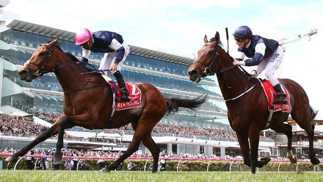 Corey Brown (L) rides #22 Rekindling to win the Emirates Melbourne Cup.