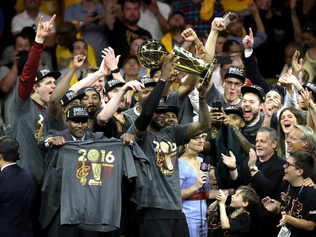 James lifts the trophy with his team.