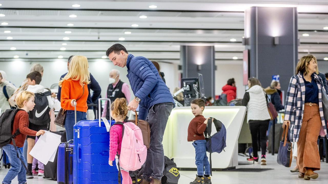 People move through the Virgin departure area at Melbourne Airport. Picture: Jake Nowakowski